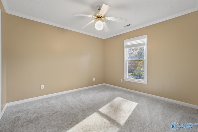 empty room with carpet flooring, ceiling fan, and crown molding