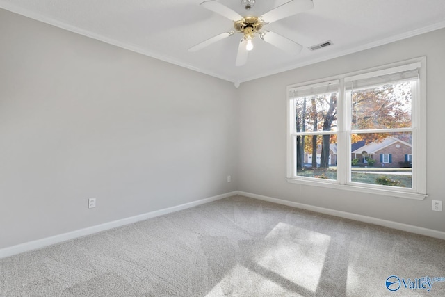 carpeted empty room with ceiling fan and ornamental molding