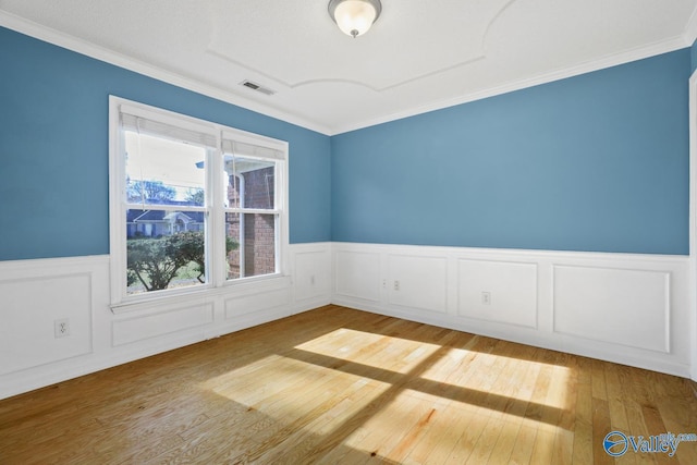 unfurnished room featuring light hardwood / wood-style flooring and ornamental molding