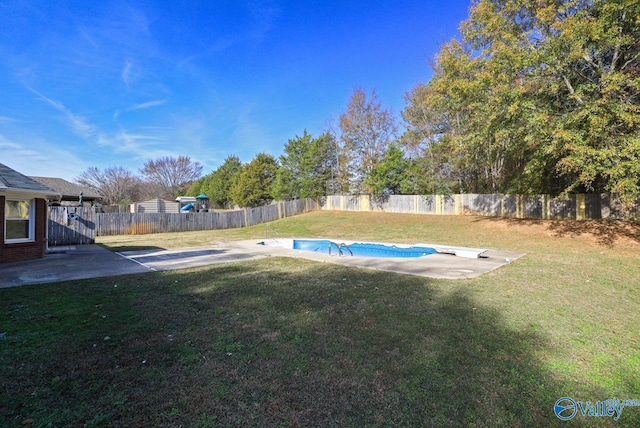 view of yard featuring a fenced in pool and a patio