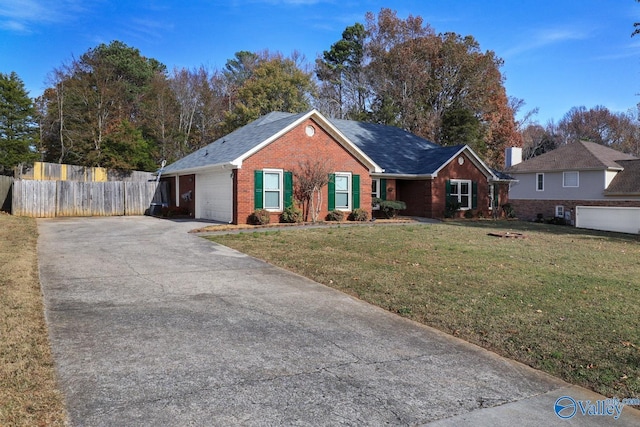 ranch-style house featuring a garage and a front yard