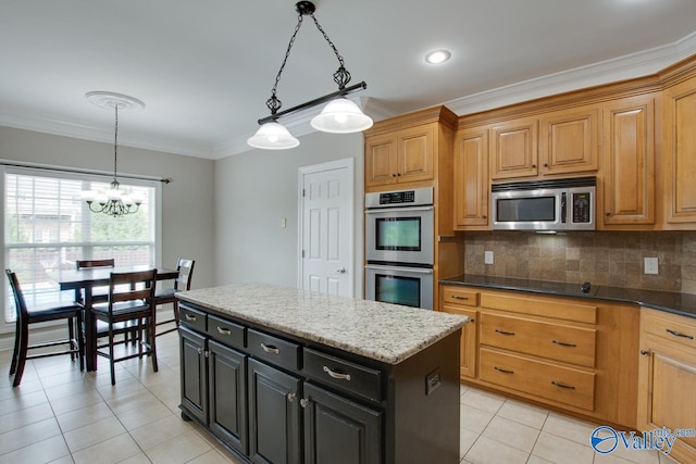 kitchen with decorative light fixtures, ornamental molding, stainless steel appliances, and a chandelier