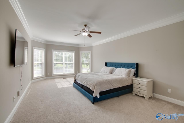 carpeted bedroom with ceiling fan and crown molding