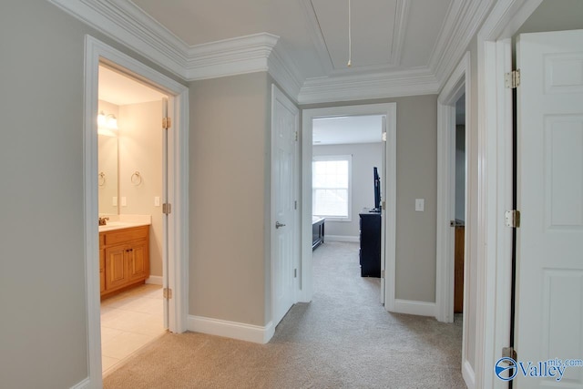 hall with light carpet, crown molding, and sink