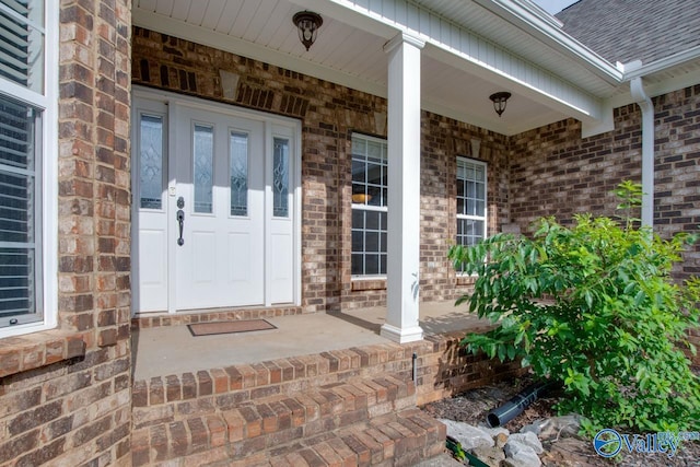 view of exterior entry with a porch