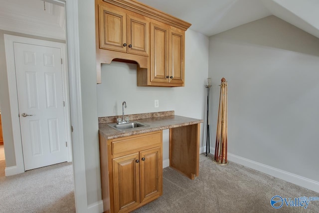 kitchen featuring light colored carpet, lofted ceiling, and sink