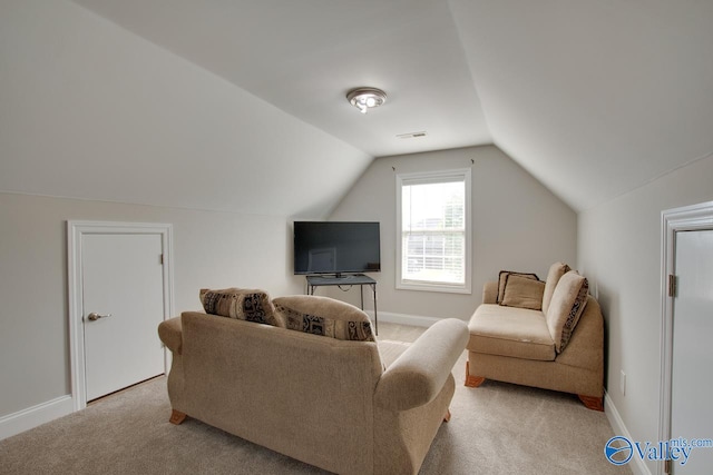 carpeted living room with vaulted ceiling