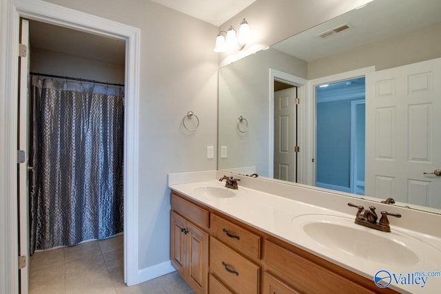 bathroom featuring walk in shower, vanity, and tile patterned floors