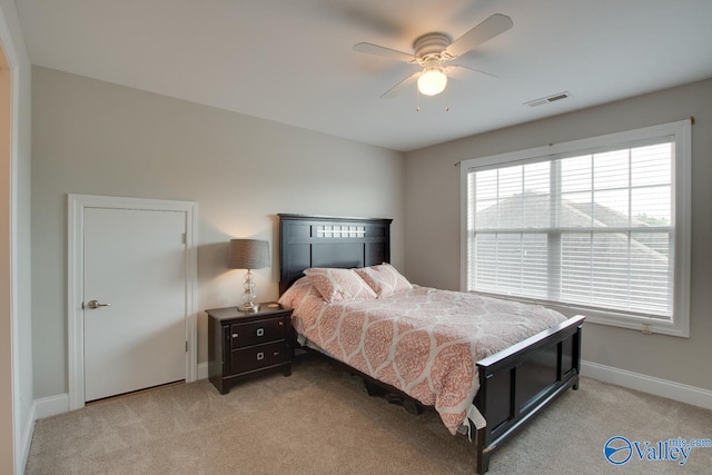 bedroom with ceiling fan and light colored carpet