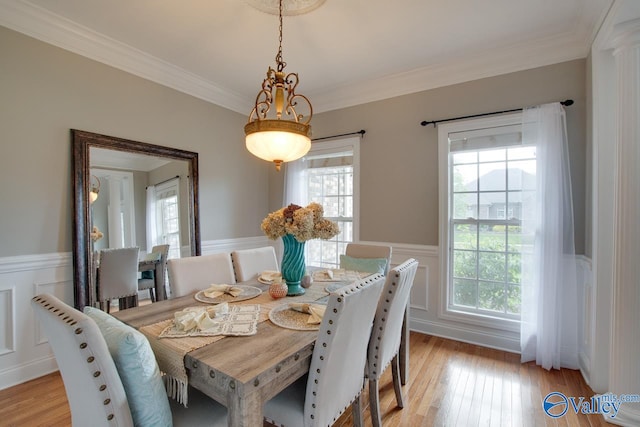 dining space featuring a wealth of natural light, light wood-type flooring, and crown molding