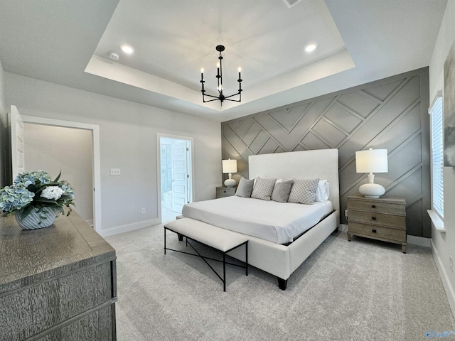 bedroom with a notable chandelier, ensuite bath, light colored carpet, and a raised ceiling