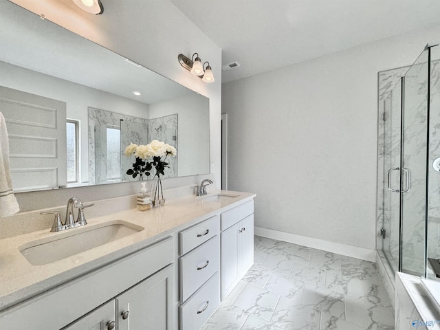 bathroom with vanity and a shower with shower door