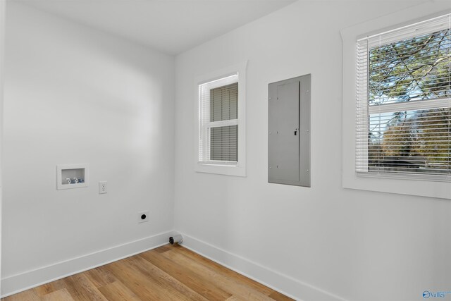 laundry area with hookup for an electric dryer, washer hookup, electric panel, and hardwood / wood-style flooring