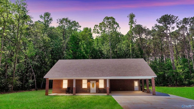 1201 Larry Dr, Scottsboro, AL 35769 - view of front facade with concrete driveway, a front lawn, an attached carport, and brick siding