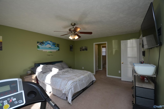 bedroom featuring carpet floors, a ceiling fan, baseboards, and a textured ceiling