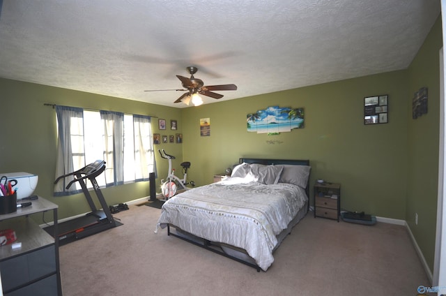 bedroom with a textured ceiling, carpet floors, ceiling fan, and baseboards