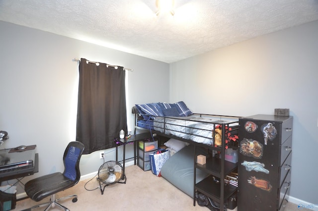 bedroom featuring carpet, baseboards, and a textured ceiling