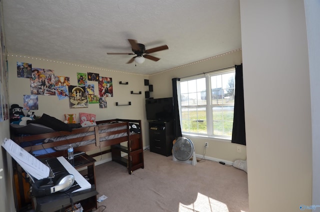 bedroom with light carpet, ceiling fan, baseboards, and a textured ceiling