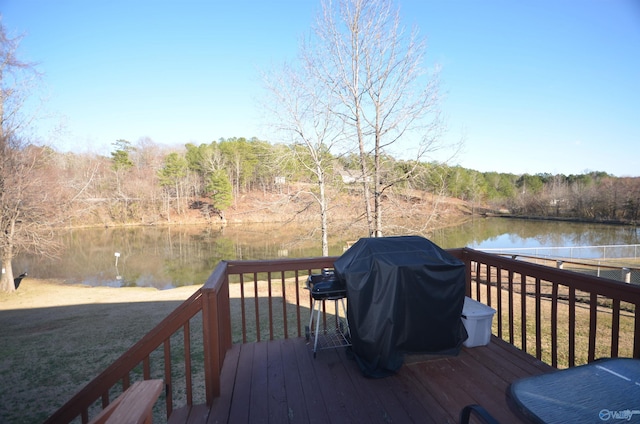 wooden terrace with a water view and a grill