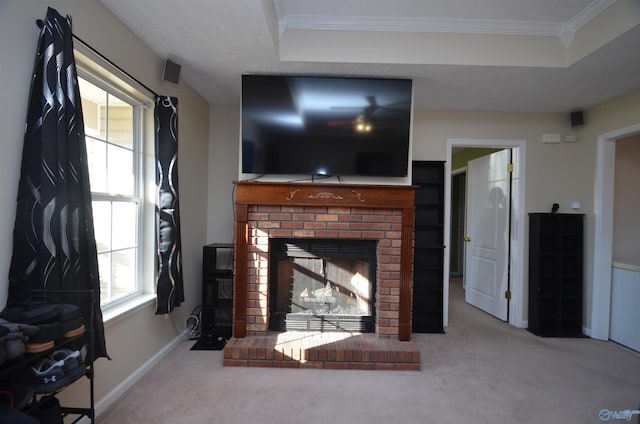 living area with carpet floors, baseboards, a fireplace, and ornamental molding