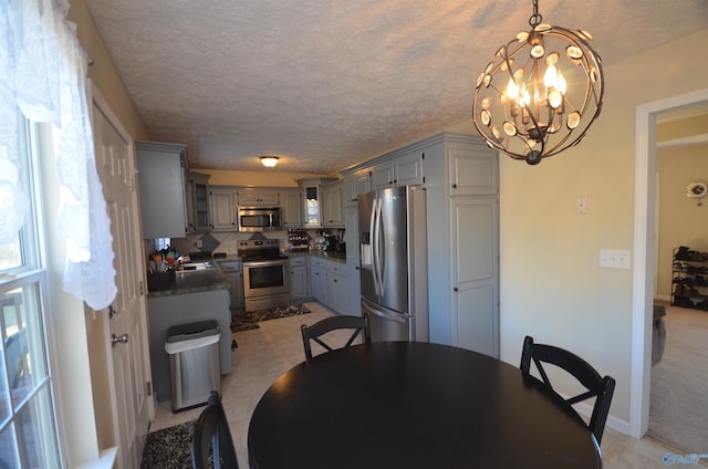 dining area featuring a notable chandelier and a textured ceiling