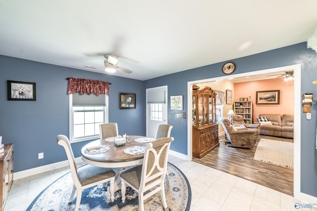 dining room with light tile patterned floors, ceiling fan, visible vents, and baseboards
