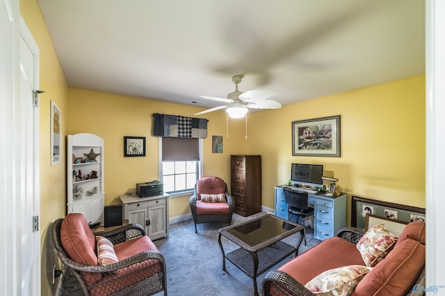 carpeted living area featuring a ceiling fan