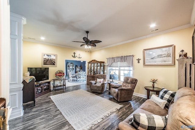 living room with visible vents, ornamental molding, and a ceiling fan