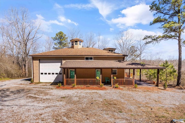 view of front of property with covered porch, driveway, and a shingled roof