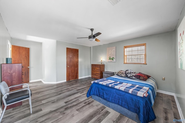 bedroom featuring visible vents, baseboards, and wood finished floors