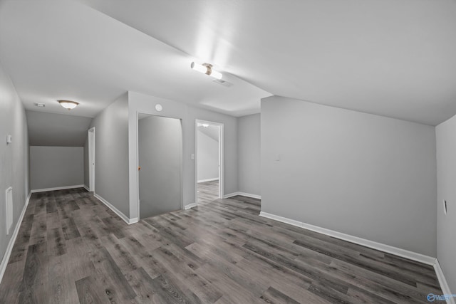 bonus room featuring lofted ceiling, baseboards, and wood finished floors