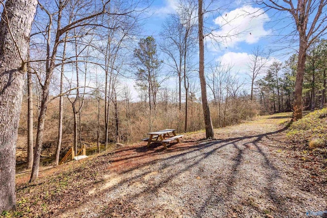 view of street featuring a wooded view