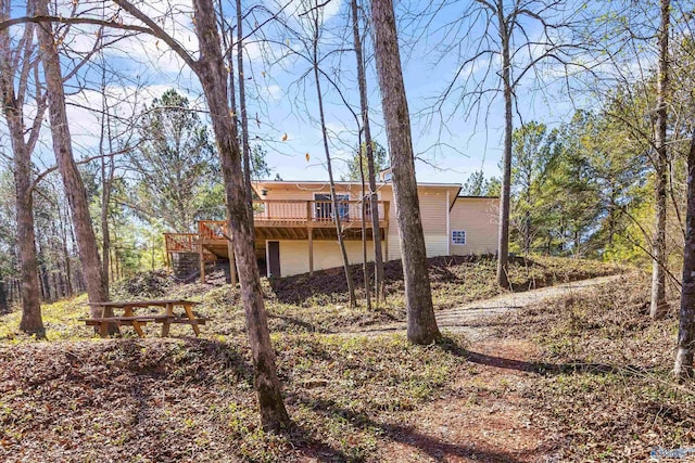 back of house with a wooden deck