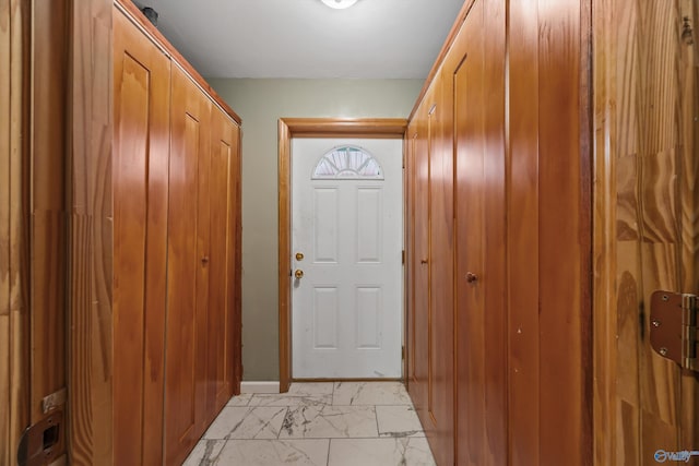 entryway featuring marble finish floor and baseboards