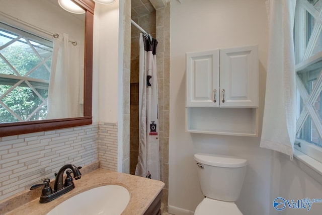 full bathroom featuring tasteful backsplash, curtained shower, vanity, and toilet