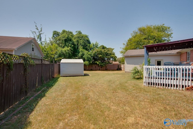 view of yard with a shed, an outdoor structure, and a fenced backyard