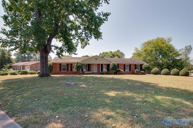 single story home with brick siding and a front yard