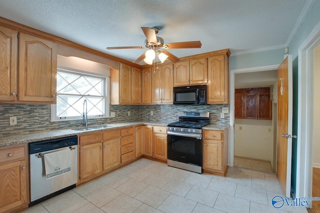 kitchen with decorative backsplash, appliances with stainless steel finishes, ornamental molding, a sink, and light stone countertops