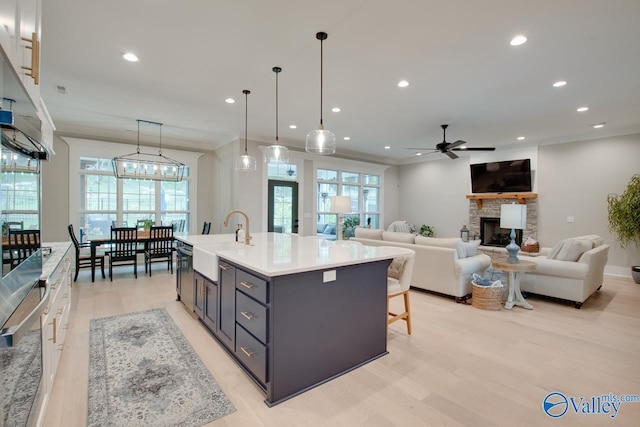 8076 Goose Ridge Dr, Owens Cross Roads, AL 35763 - kitchen featuring a sink, a fireplace, ceiling fan, plenty of natural light, and recessed lighting