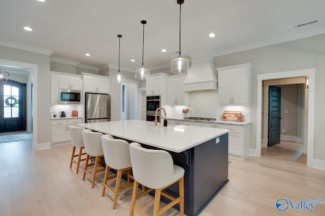 8076 Goose Ridge Dr, Owens Cross Roads, AL 35763 - kitchen with stainless steel appliances, custom exhaust hood, tasteful backsplash, crown molding, and light countertops