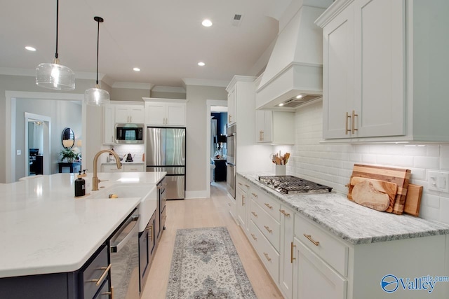 8076 Goose Ridge Dr, Owens Cross Roads, AL 35763 - kitchen with custom exhaust hood, stainless steel appliances, crown molding, backsplash, and white cabinetry