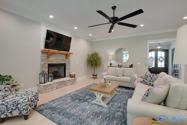 8076 Goose Ridge Dr, Owens Cross Roads, AL 35763 - living room featuring wood finished floors, a ceiling fan, crown molding, a stone fireplace, and recessed lighting