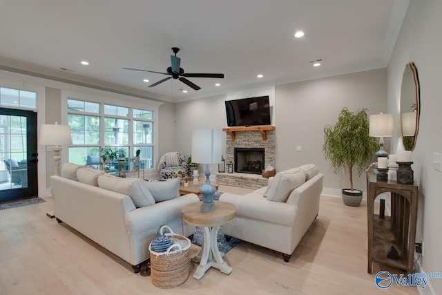 8076 Goose Ridge Dr, Owens Cross Roads, AL 35763 - living area with a stone fireplace, light wood-type flooring, crown molding, ceiling fan, and recessed lighting