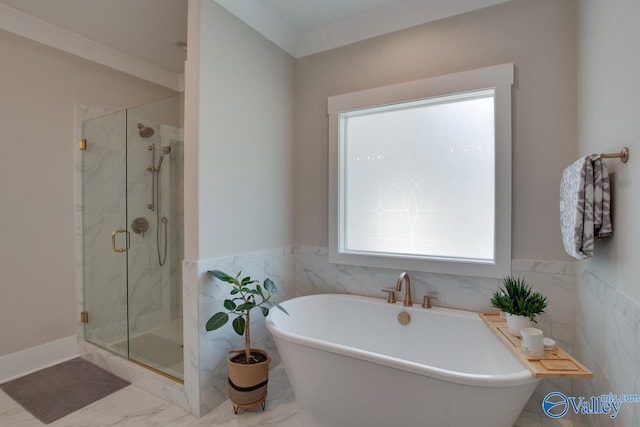 8076 Goose Ridge Dr, Owens Cross Roads, AL 35763 - full bathroom with a freestanding bath, a marble finish shower, marble look tile flooring, tile walls, and a wainscoted wall