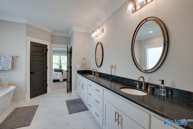 8076 Goose Ridge Dr, Owens Cross Roads, AL 35763 - ensuite bathroom with double vanity, marble look tile flooring, a freestanding tub, and ornamental molding