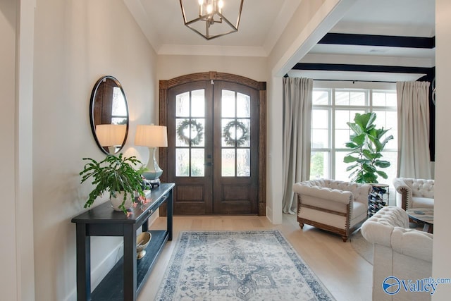 8076 Goose Ridge Dr, Owens Cross Roads, AL 35763 - entrance foyer featuring french doors, a chandelier, and wood finished floors