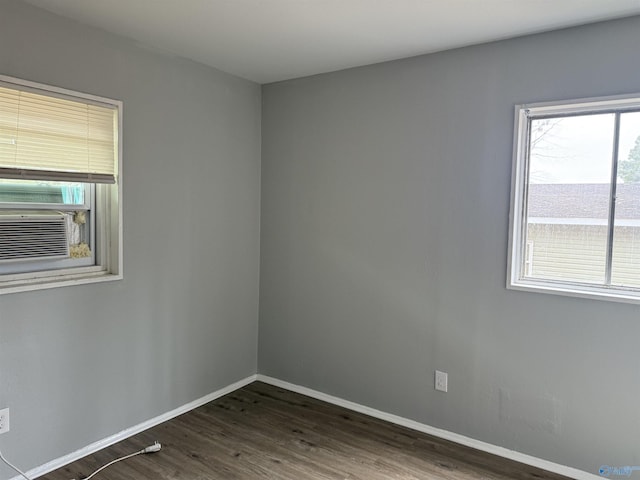 spare room with dark hardwood / wood-style flooring and cooling unit