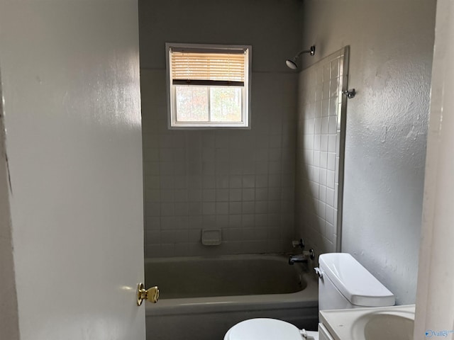 full bathroom with vanity, tiled shower / bath combo, and toilet