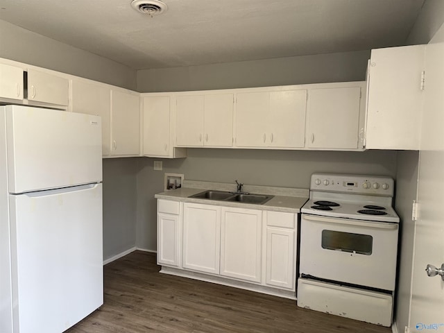 kitchen with white appliances, dark hardwood / wood-style floors, white cabinetry, and sink