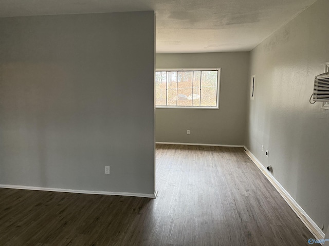 spare room with dark wood-type flooring